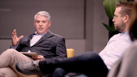 A photo of Jeff Walpole seated and speaking during a panel discussion